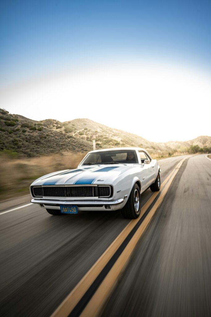 Classic car driving on the road, representing auto insurance quotes